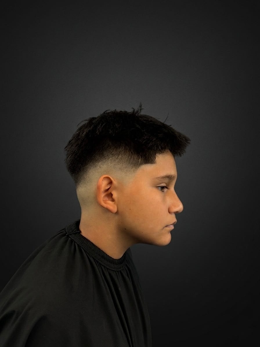 Young gent — mid fade — textured top — Juan Zapata, barber in Davie, FL